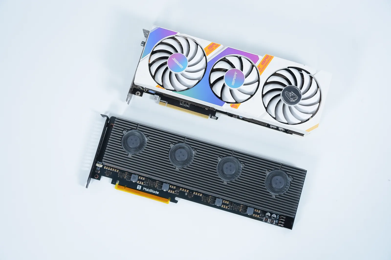 MaixBlade next to a triple-fan desktop graphics card